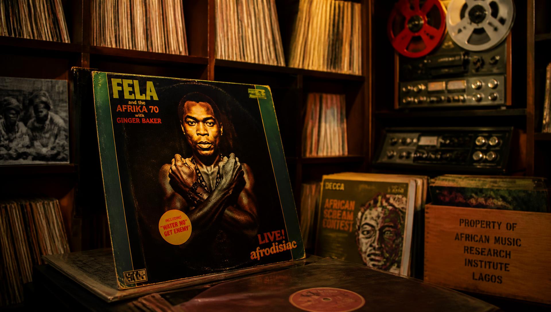 Vintage African vinyl records and reel-to-reel tape machines in an archive room